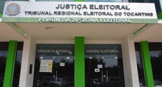 A imagem mostra a fachada do cartório da 29ª ZE de Palmas. Na parte superior, há uma placa com o...