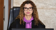 A imagem mostra a juíza Edssandra Barbosa sentada em uma cadeira no Pleno do TRE-TO, em posição ...