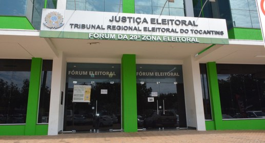 A imagem mostra a fachada de um prédio institucional da Justiça Eleitoral. Na parte superior, há...